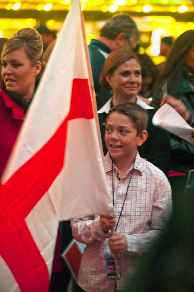 A Clark County School District student carries the team England flag during the opening ceremonies and parade for the USA Sevens International Rugby Tournament at the Fremont Street Experience on Thursday, Jan. 23, 2014.